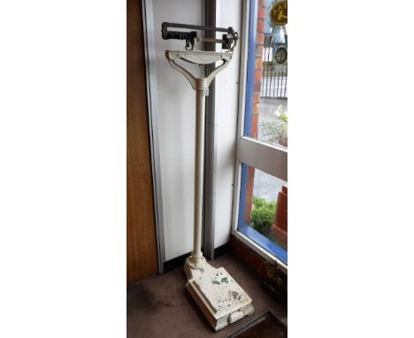 A SET OF VINTAGE CAST-IRON PERSONAL SCALES with brass fittings 62" high
