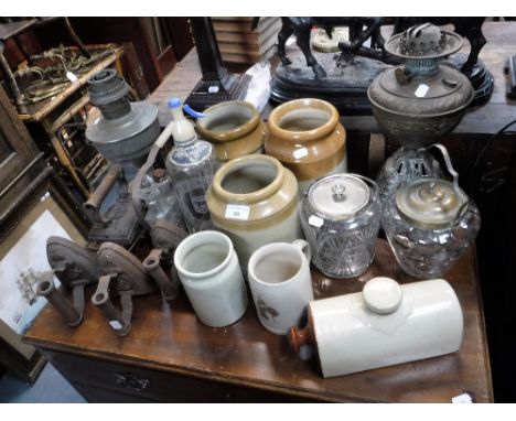 A VICTORIAN OIL LAMP, with cast iron base, a collection of flat irons, stoneware jars and sundries