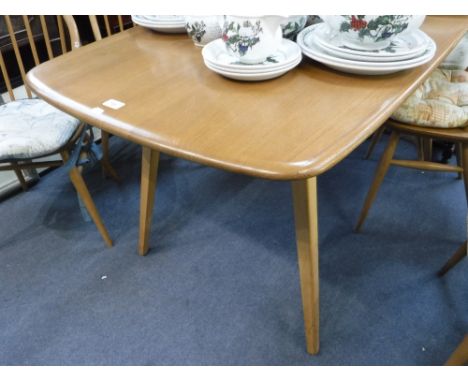 ERCOL; A PALE ELM DINING TABLE of rectangular form, on beech legs, 29" wide x 59" long