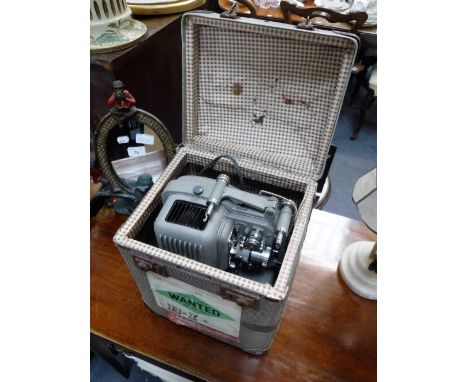 A VINTAGE 'FILMO' PROJECTOR in a period case, with interesting travelling labels including 'British Steam Navigation Company'