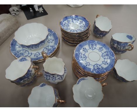 A part blue and white gilded tea service
