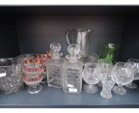 A shelf of cut glass including water jug and decantaner