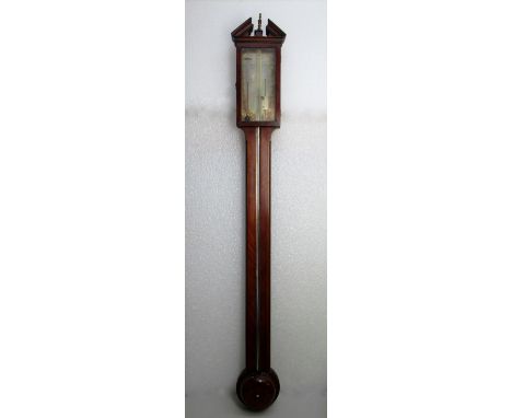 GEORGIAN MAHOGANY STICK BAROMETER WITH A BROKEN ARCH PEDIMENT ABOVE A GLAZED DOOR, THE SILVERED REGISTER PLATE ENGRAVED WITH 