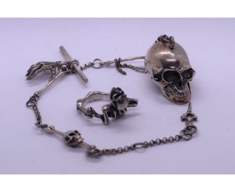 Silver Albert chain in the form of a skull and hand together with a silver creeping skull ring 