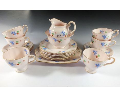 A Tuscan tea service painted blue flowers comprising six cups and saucers, milk, sugar, six tea plates and cake plate 
