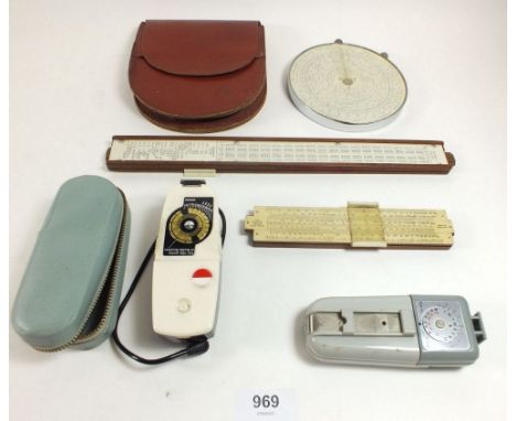 A Fowlers Longscale calculator in leather pouch,  two slide rules and two light meters 