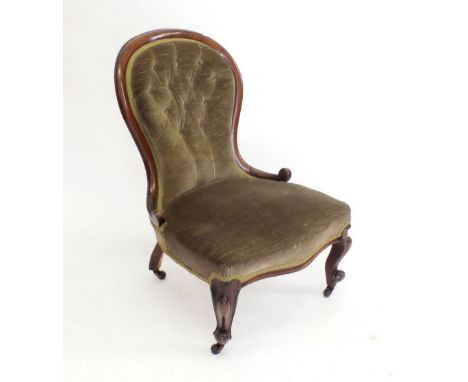A Victorian mahogany button upholstered chair on scroll supports 