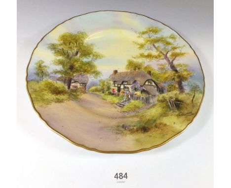 A Royal Worcester plate painted 'Thatched Cottage at Wick' signed A Wallcraft, 27cm diameter 