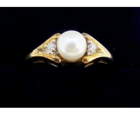 A 9 carat gold ring set pearl flanked by diamond chips, size N, 2.5g 