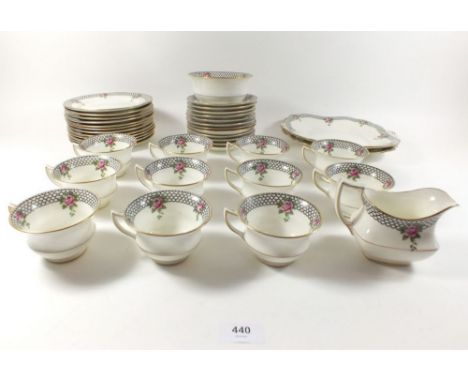 An Aynsley tea service with rose and black scale borders comprising: eleven cups and saucers, two cake plates, twelve tea pla