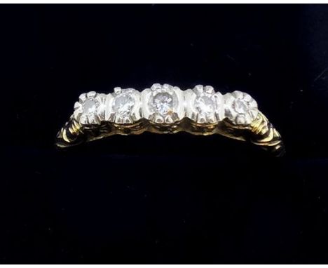 A 14 carat gold ring circa 1920's illusion set five diamonds, size P 