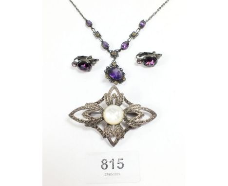 A large vintage silver and mother of pearl brooch and a necklace and earrings set purple stones 