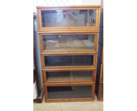 A Globe Wernicke oak bookcase with four sections and additional top section, 86.5 cm wide by 30cm deep 