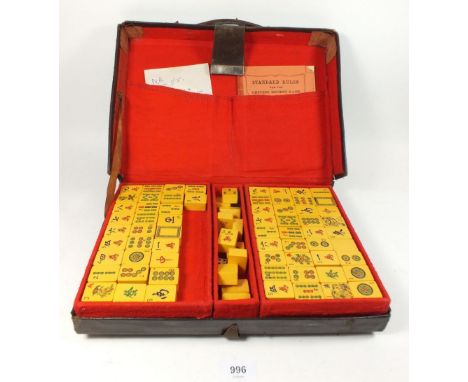 A vintage mid 20thC mahjong set in leather case together with two lacquered marker trays 
