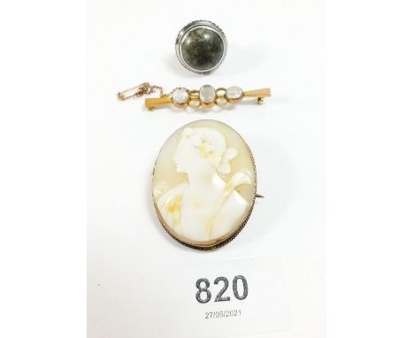 An early 20thC cameo brooch set yellow metal frame, together with a moonstone set yellow metal bar brooch and silver and hard