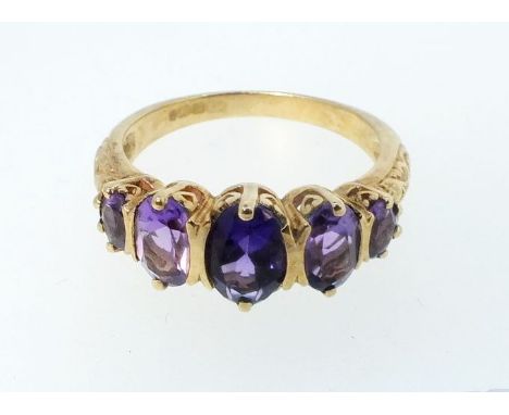 A 9ct gold ring set five amethysts, size N, 3g 