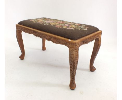 An oriental carved two seater stool with tapestry top and carved ivy leaf decoration 