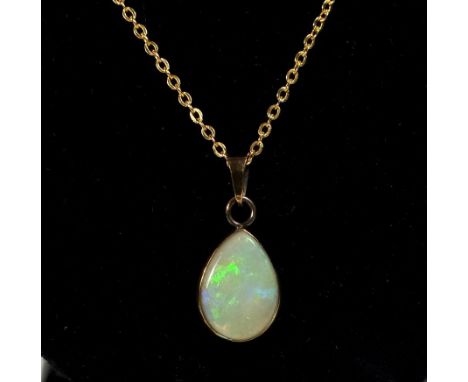 A 9 carat gold tear drop form opal pendant on gold plated chain 