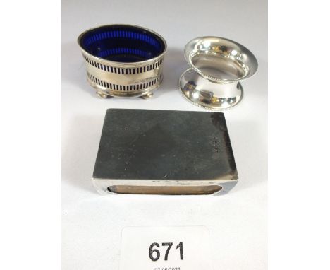 A silver napkin ring, salt pot and matchbox holder, 65g