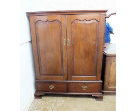 A 19th century mahogany Georgian style gentleman's wardrobe with two arch panel doors above two drawers, all on ogee bracket 