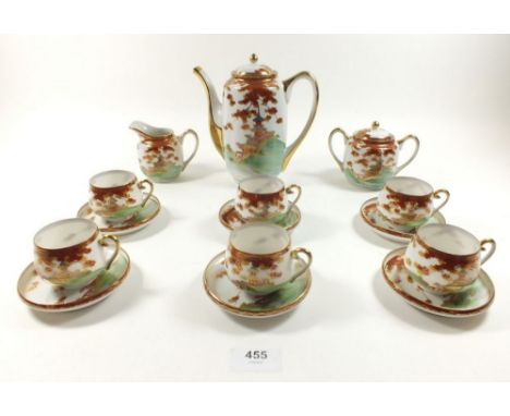 A Japanese eggshell tea service comprising: six cups and saucers, teapot, milk and sugar - all boxed 