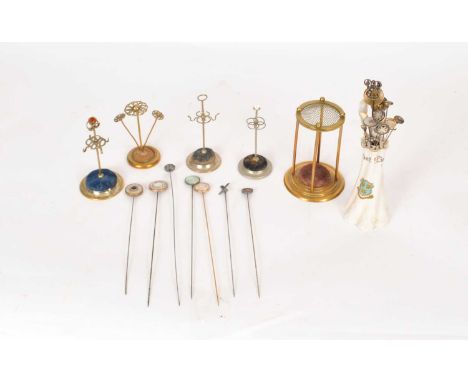 A collection of hat pins and stands, to include; mother of pearl examples, a satsuma example, two yellow metal bead terminal 