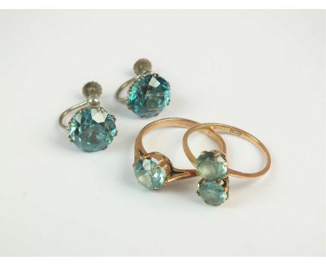 A two stone blue zircon crossover ring, stamped '9ct', size M, together with a single stone blue zircon ring, size L and a pa