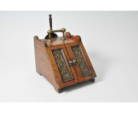 A large Victorian oak coal box, with inset relief moulded brass hinged panelled doors, brass handle and trowel, with interior