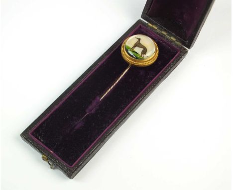 A reverse intaglio stick pin depicting a Greyhound, collet set in yellow metal with beaded border, the reverse engraved 'Miss