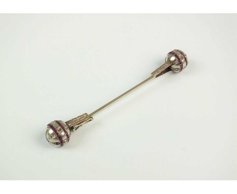 A ruby and diamond orb jabot pin, each orb terminal set with rose cut diamonds and channel set square faceted rubies, 70mm lo