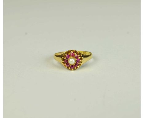 A 15ct gold pearl and ruby ring, designed as a central single untested pearl mounted within a surround of eight ruby chips, r