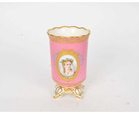 A Coalport spill vase circa 1861-75 of cylindrical form, raised on four feet, the pink pompadour ground decorated with an ova