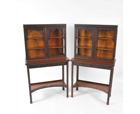 A pair of Edwardian mahogany Chippendale revival cabinets on two drawer stands, with concave open shelf stretcher, each overa