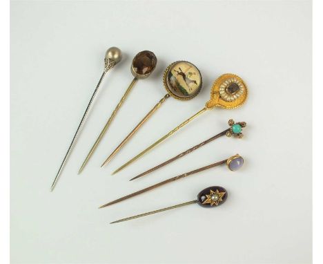 A collection of seven stick pins, comprising; a cabochon garnet and seed pearl example, a rose cut diamond and untested pearl