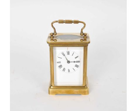 A small brass cased carriage clock, with a white enamel dial with black Roman numerals, 14.5cm high (including handle when up