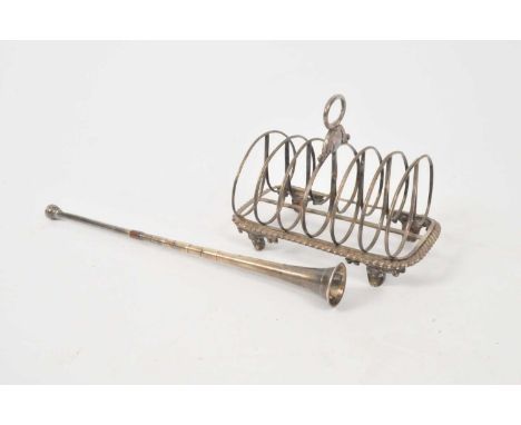 A William IV silver six division toast rack, Barnard Brothers, London 1834, with central loop handle and raised on four brack