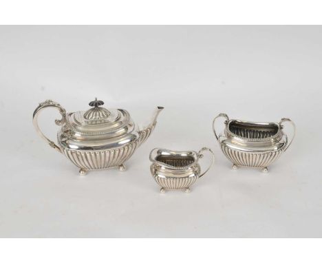 An Edwardian three piece silver tea service, James Dixon and Sons, Sheffield 1902 &amp; 1904, each piece of half reeded form,