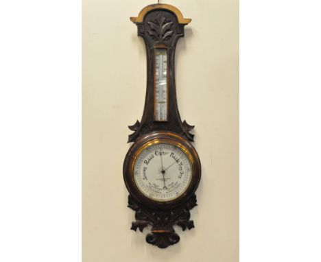 An early 19th century mahogany '5 dial' wheel barometer, the broken swan neck pediment above a dry/damp dial, over a theromet