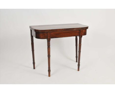 A 19th century mahogany veneered card table, with a hinged top with rounded corners over turned tapering legs, 73 cm high, th