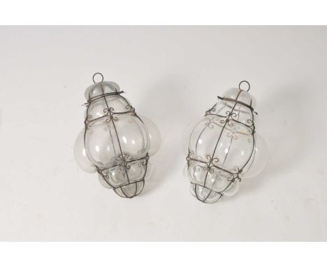 A pair of clear glass wire framed ceiling lights, a modern three-light gilt chandelier and a small five-light ceramic and cas