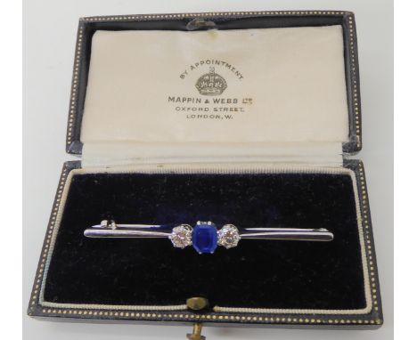 A sapphire and diamond three stone white metal bar brooch in Mappin &amp; Webb box, length of brooch 5.2cm, set with estimate