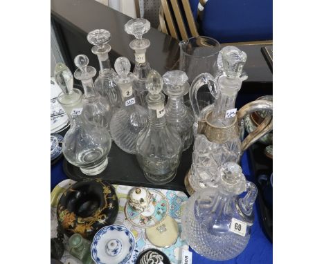 A lot comprising a selection of cut glass and crystal decanters, including an example by Forster Glass Co, one with white met