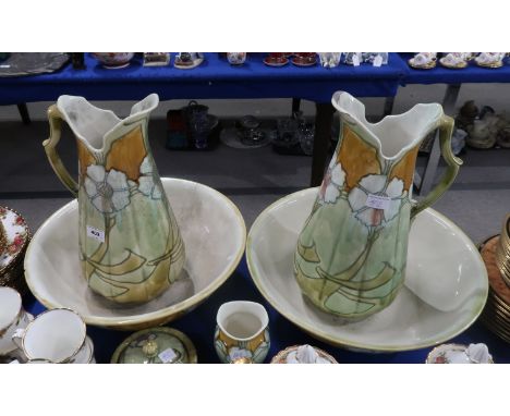 A pair of Minton Secessionist washbowls and ewers, a tooth mug and a soap dish, with tube line decoration of flowers, with pr