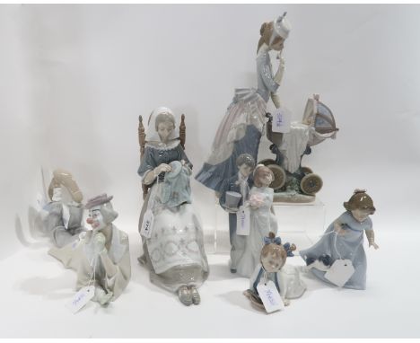 Four Lladro figures including a woman pushing a pram, a clown lying down, and a bride bride and groom, together with two Nao 