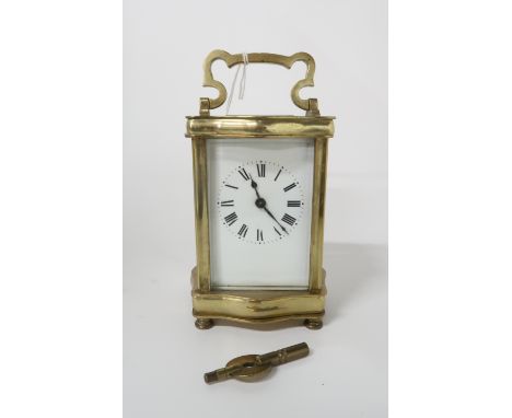 A French brass and glass carriage clock, has key Condition Report: winds and ticks. 