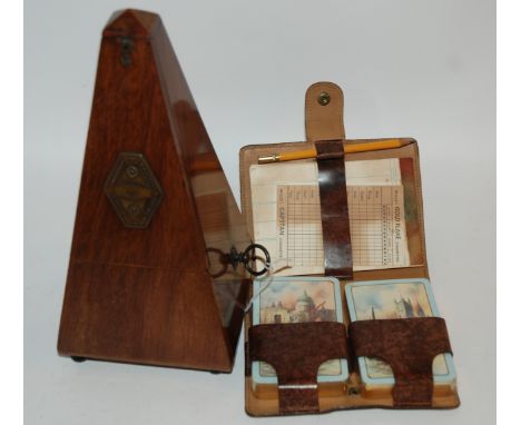 A French metronome with brass plaque, 22cm high and playing card set Condition Report: Available upon request