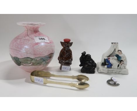 A Mdina pink glass vase, a German fairing, a Cornish Mead decanter, a buddha, a horseshoe brooch and a pair of sugar tongs Co