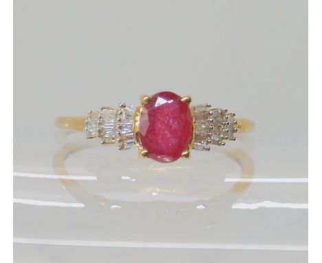 A 9ct gold ruby and baguette cut diamond ring, size V1/2, weight 2gms Condition Report: Available upon request