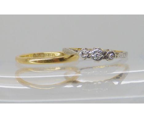 An 18ct gold wedding ring size K, together with a 18ct gold illusion set three stone diamond ring size J1/2, weight combined 