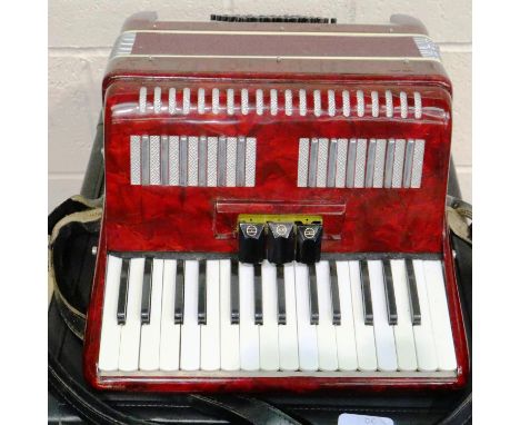 Italian junior accordion in working order with case, not named. Some splits to plastic and discolouration rattling inside but